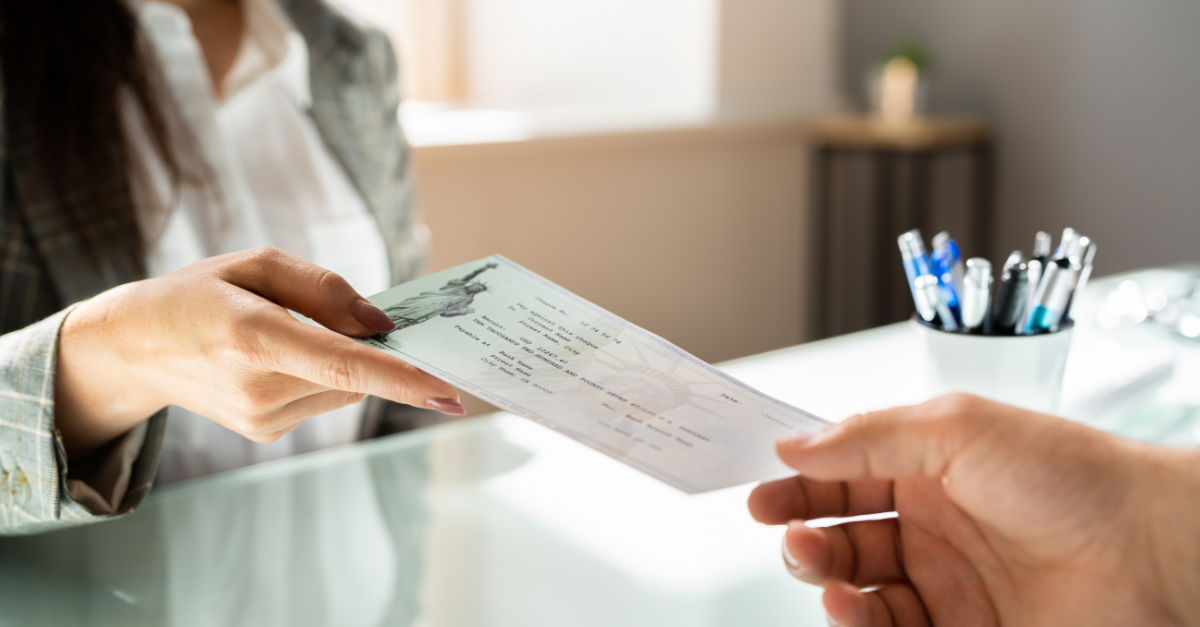 Woman Handing Out Payslip