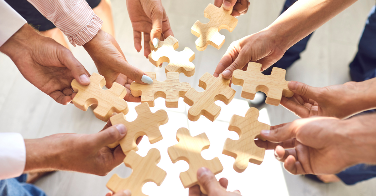 People Fitting a Puzzle